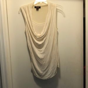 Sleeveless white top with a drop cleavage